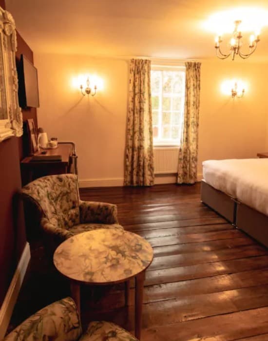 Classic room with floral armchair and ornate mirror